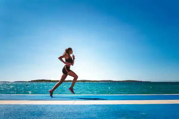 Woman running showing strong leg muscle Wisley